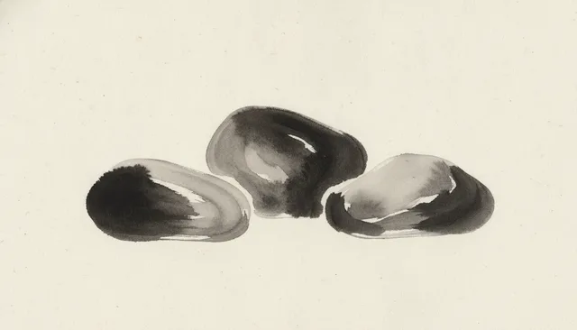 Three river stones clustered together
